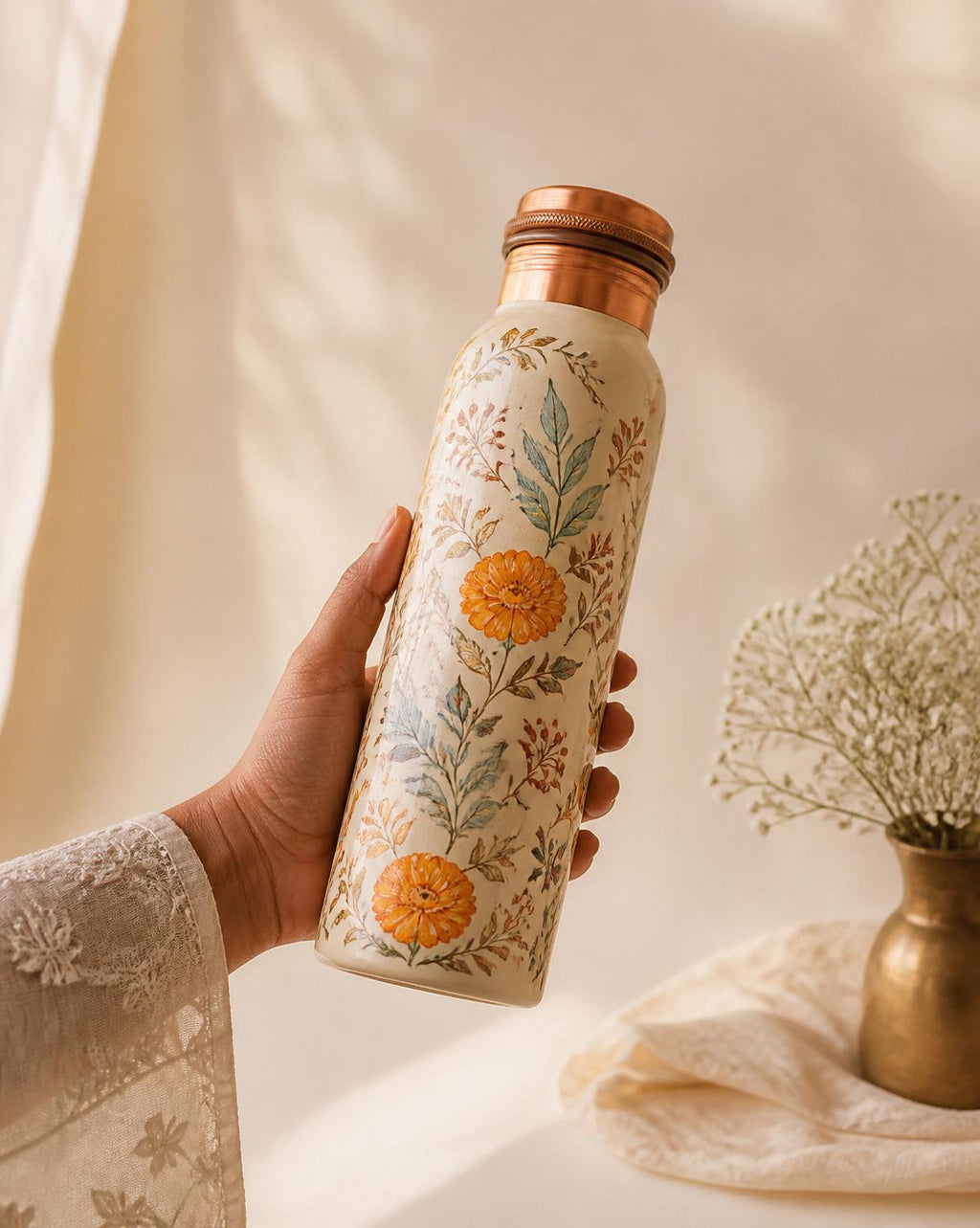 Floral copper bottle held in hand