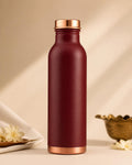 Maroon copper bottle standing