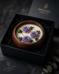 Rose sculpted candle in wooden bowl